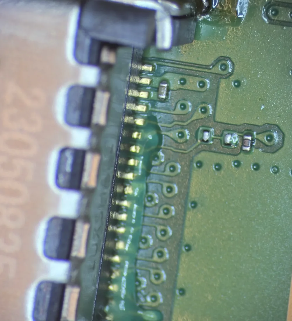 Real HDMI port solder joints and contact pins on a PS5 mainboard, photographed under magnification on the bench